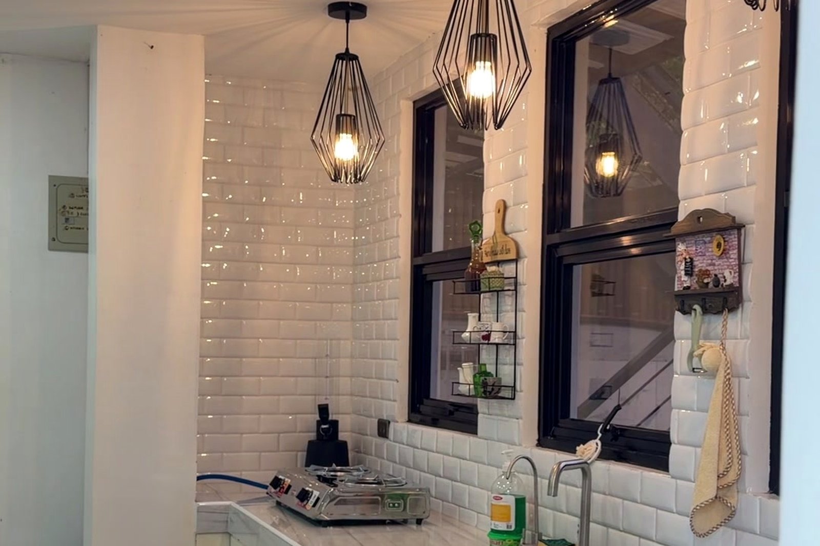Tiled kitchenette with pendant lighting